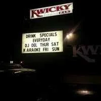 A lit signboard outside a Kwicky restaurant shows drink specials and entertainment events like DJ nights, karaoke, and karaoke on Friday, Saturday, and Sunday.