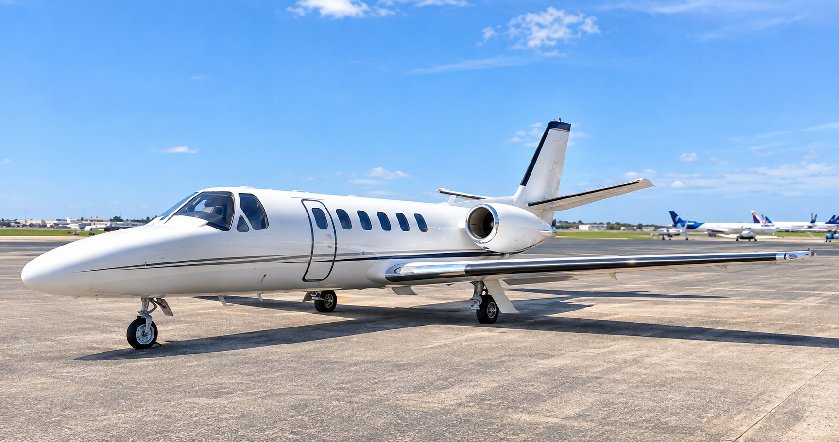 Cessna Citation Bravo private jet exterior on an airport apron, showing the light business jet from a front-side angle under a clear blue sky.