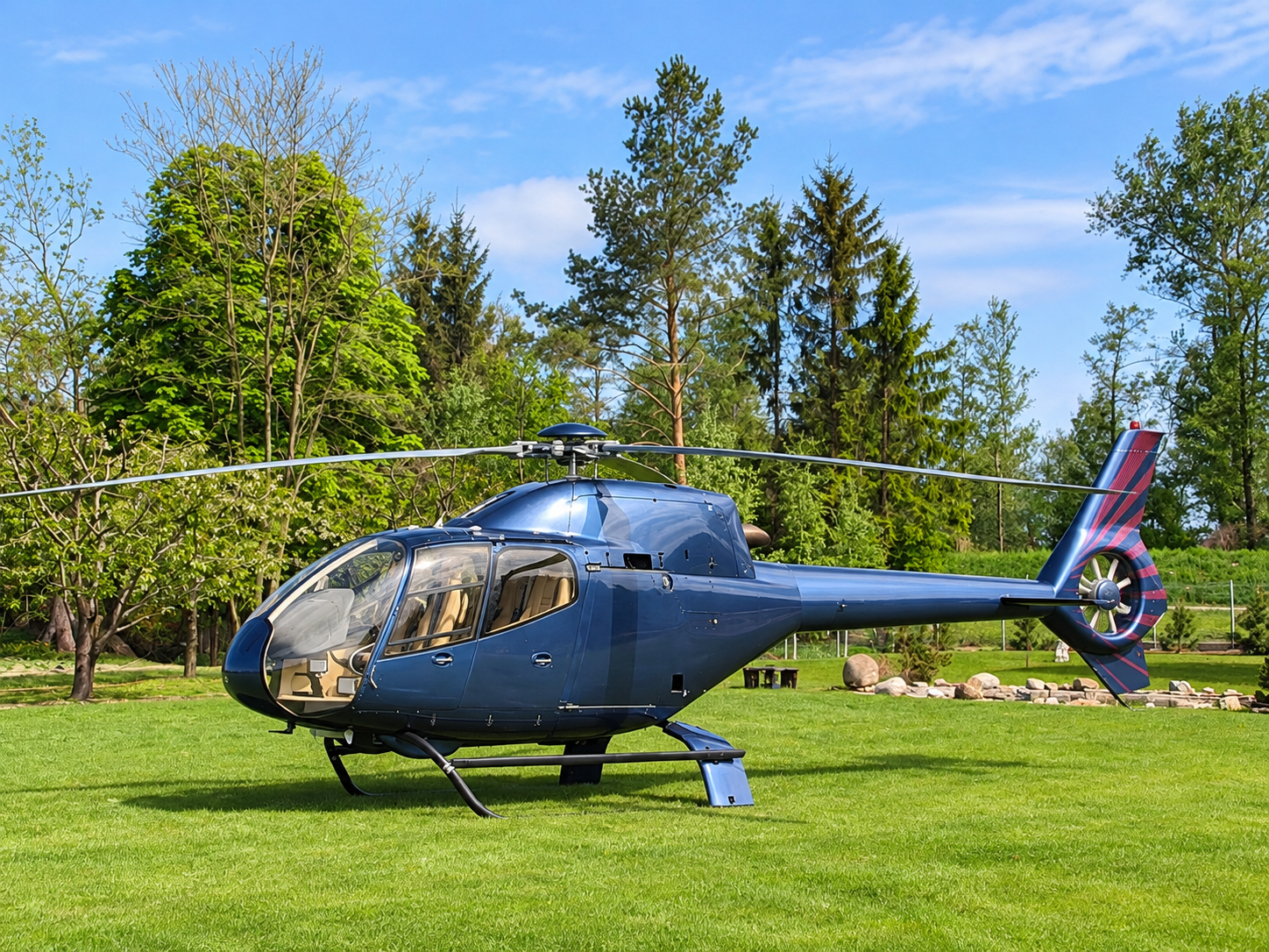 SA341 Gazelle single-engine helicopter with distinctive Fenestron tail rotor, parked on a green lawn surrounded by trees. Image Title