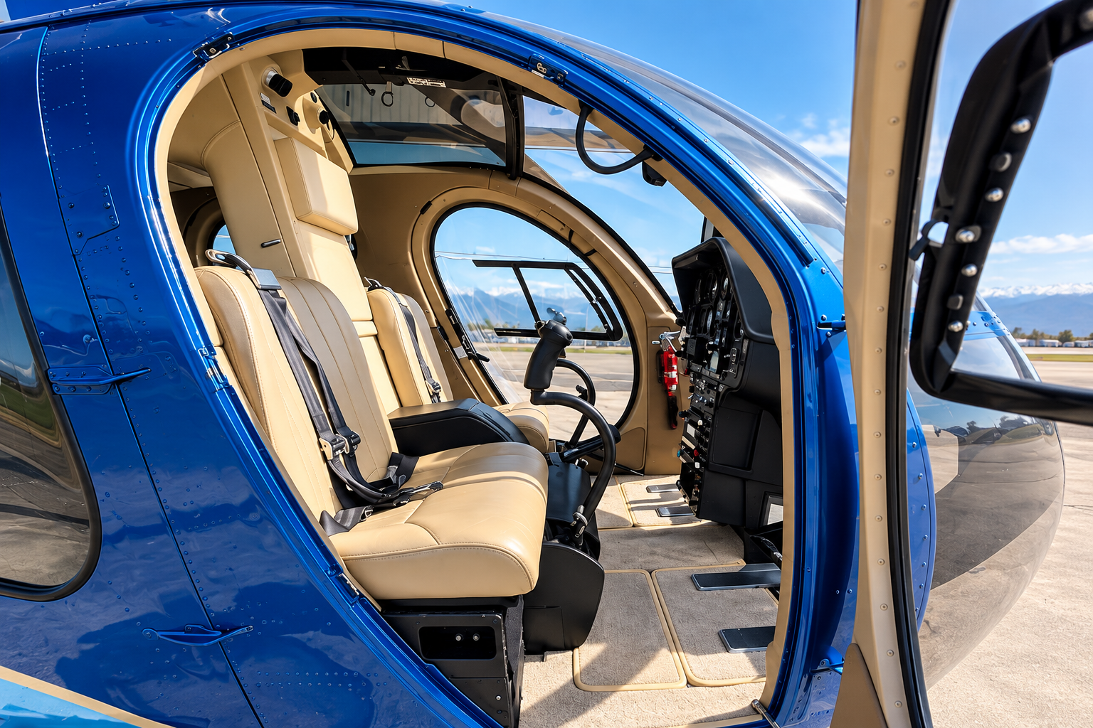 MD 500 helicopter cabin interior featuring beige leather seating, panoramic windows and cockpit controls.