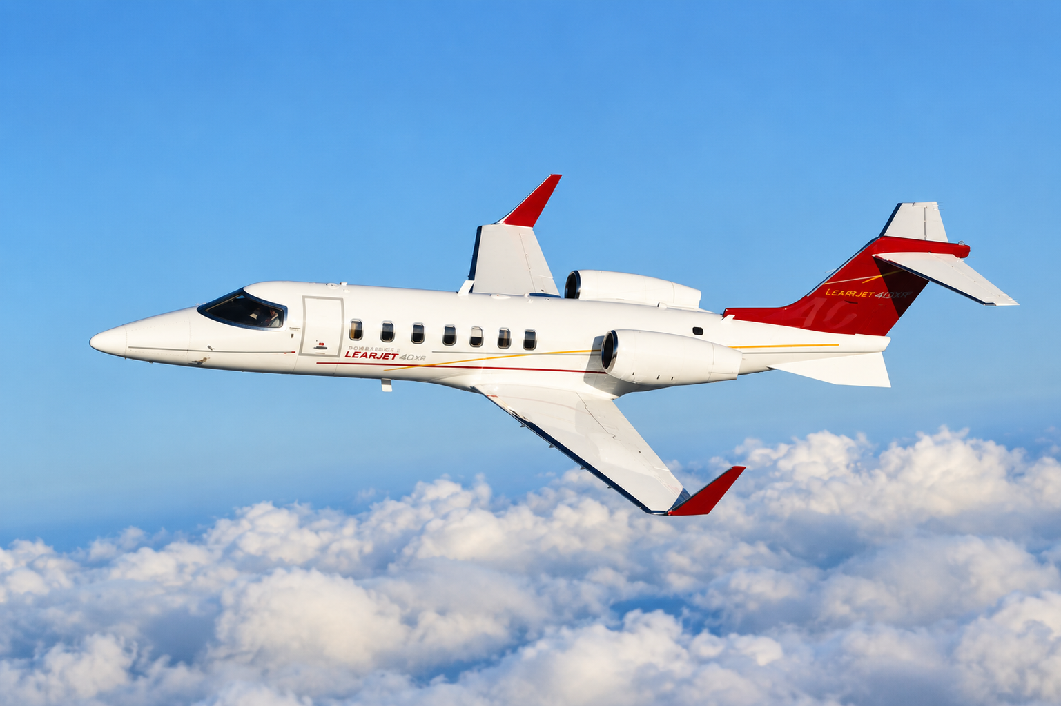 Bombardier Learjet 40XR private jet flying above the clouds, shown in a bright exterior side view against a clear blue sky.