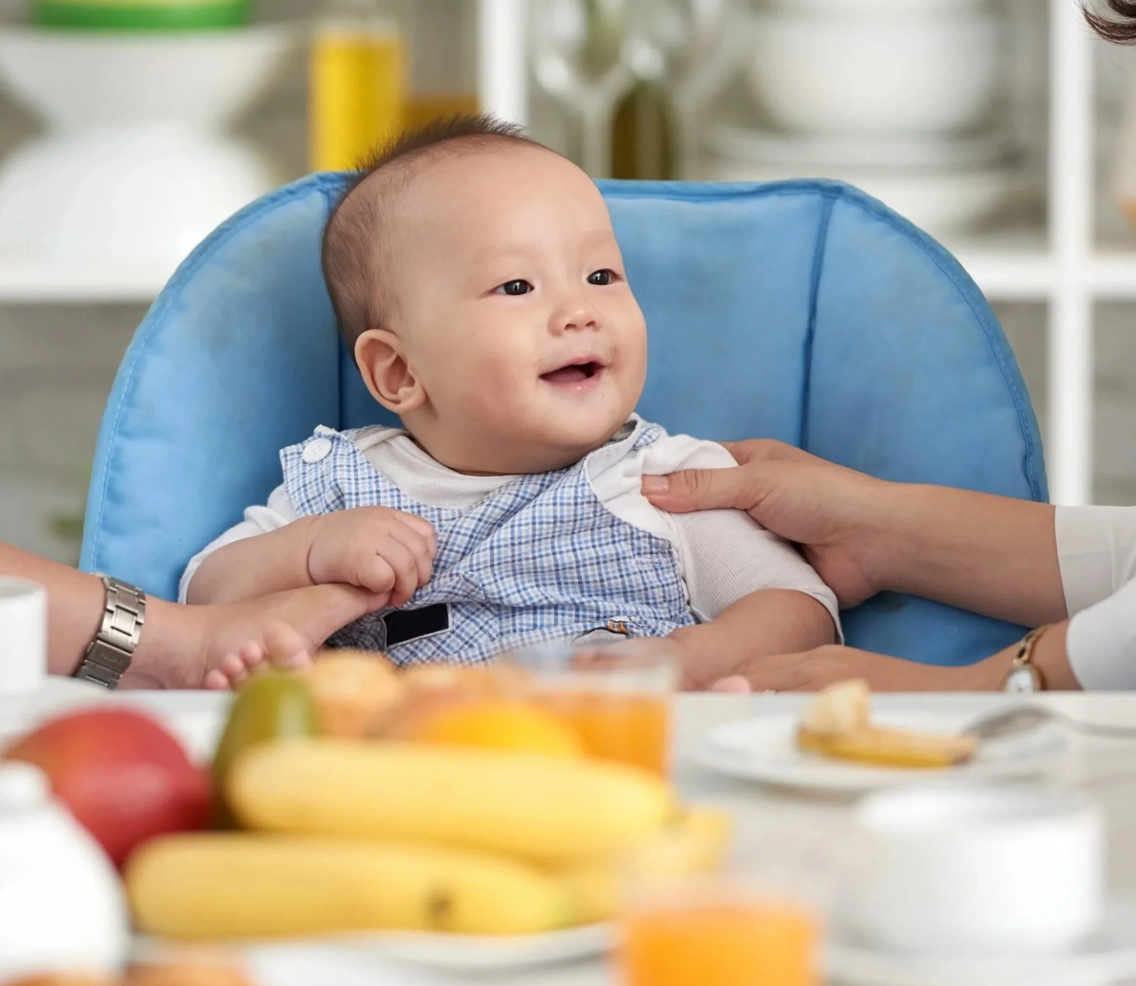 Happy baby sitting in a high chair during a pediatric feeding therapy session, supported by Flourish Therapy Service in Athens, GA.