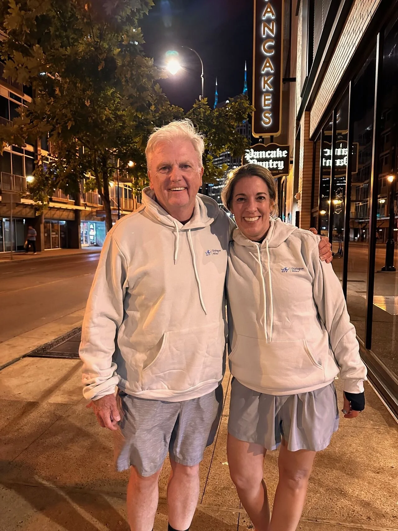 Joe and Deb in matching siY, llc branded hoodies in front of the Pancake Pantry restaurant