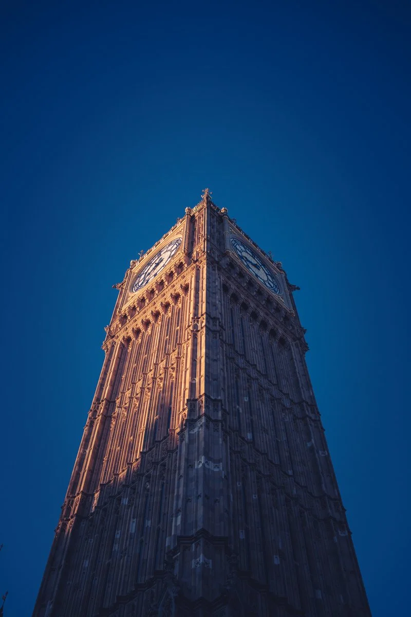 A tall clock tower, known as Big Ben, against a clear blue sky.