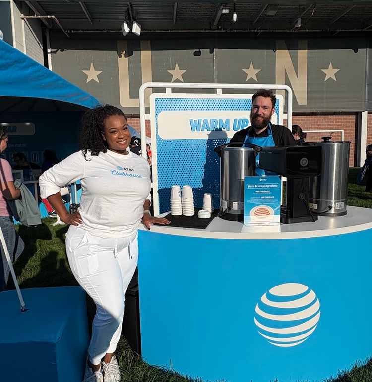 Baristas serving from an AT&T branded hot chocolate bar