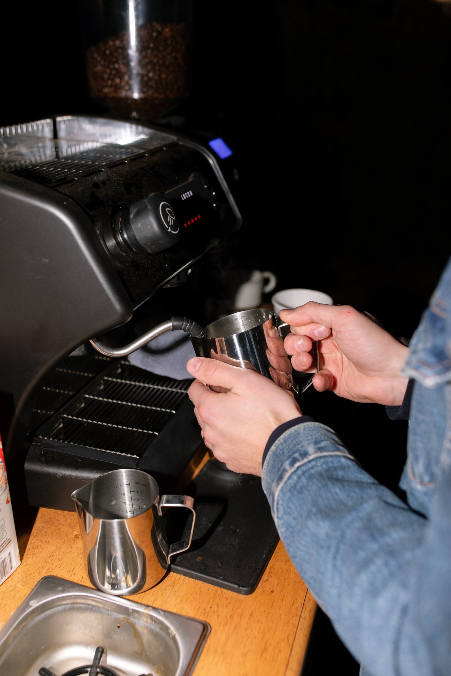 Milk being steamed beside a compact event espresso machine