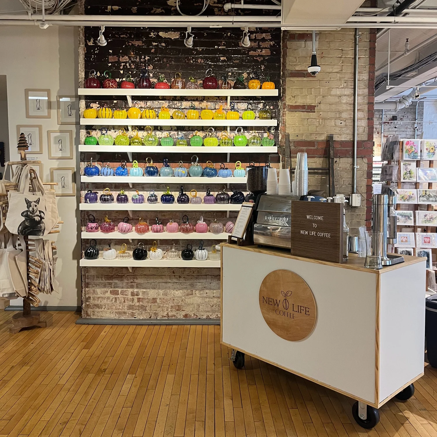 White New Life Coffee Company mobile espresso cart set up inside a colorful retail event venue