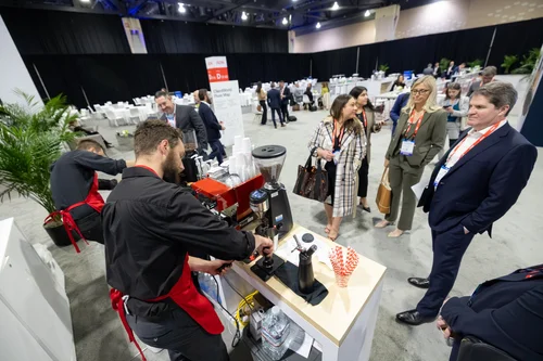 New Life Coffee Company baristas serving guests at a large conference