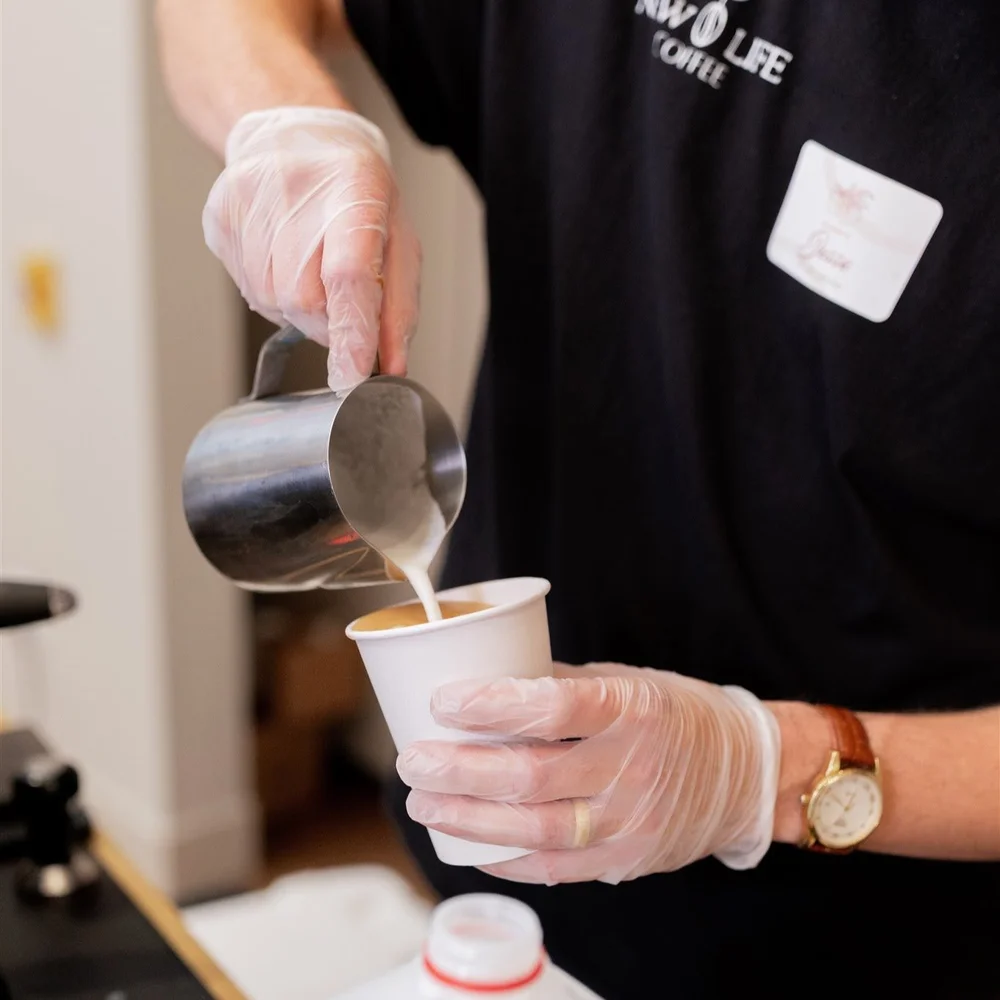 New Life Coffee Company barista handcrafting a made-to-order drink