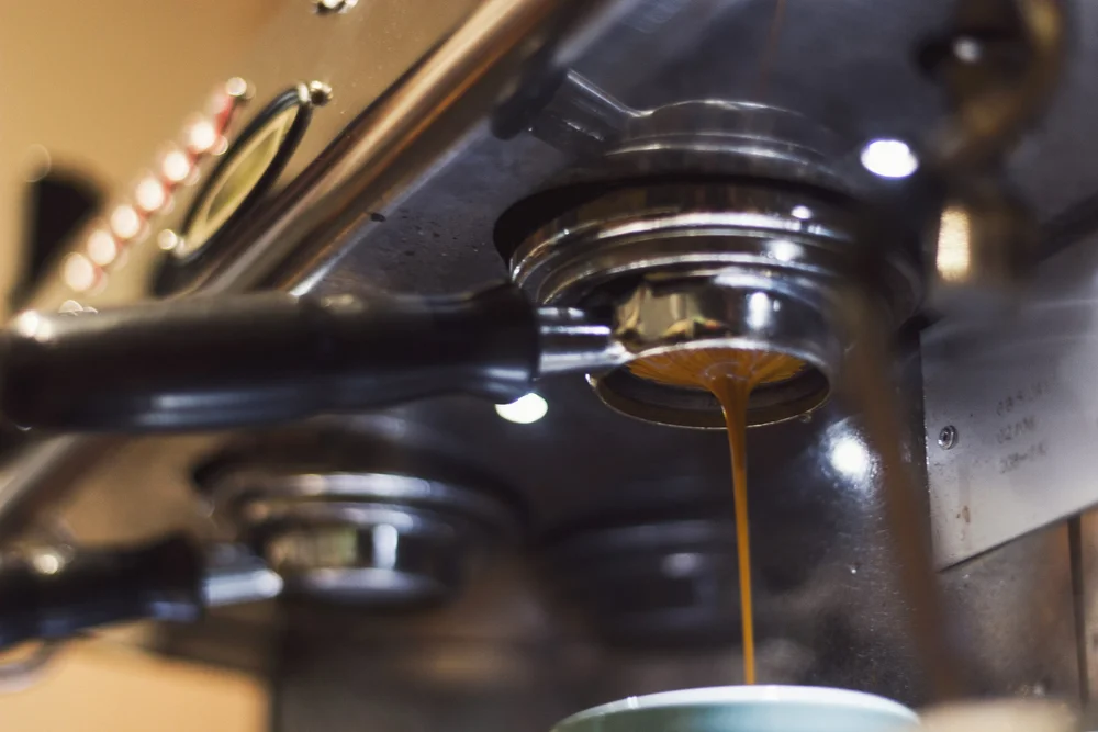 Espresso pouring from a commercial espresso machine