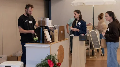 Guests ordering handcrafted drinks from a wedding espresso bar