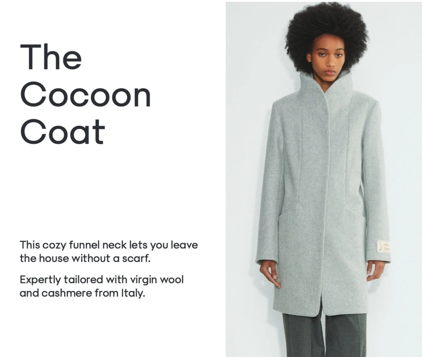 A woman wearing a light gray cocoon coat with a high collar, standing against a plain light background, with text describing the coat as crafted from virgin wool and cashmere from Italy.