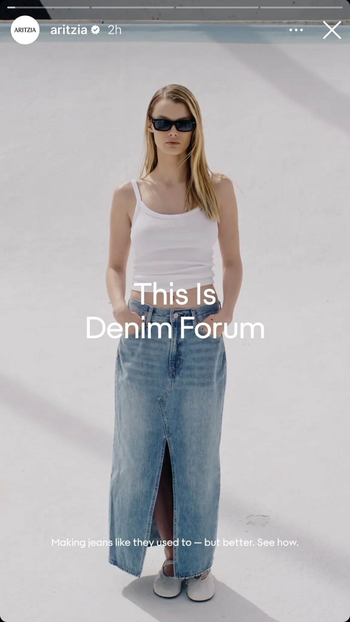 A woman wearing sunglasses, a white tank top, and a long denim skirt standing in a white open space. Text on the image reads: "This Is Denim Forum. Making jeans like they used to — but better. See how."