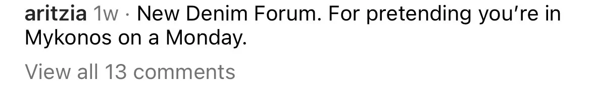 Close-up of a social media comment section showing a comment about a New Denim Forum and pretending to be in Mykonos on a Monday, with an option to view all 13 comments.