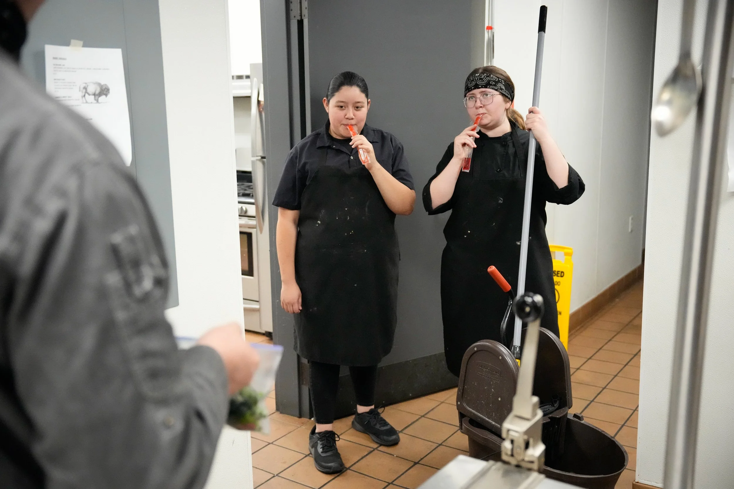 Chefs Rosalia and Jenna eat ice pops while working their closing shift at Babz Bistro in Maysville, N.Y. on Oct. 24, 2025. 