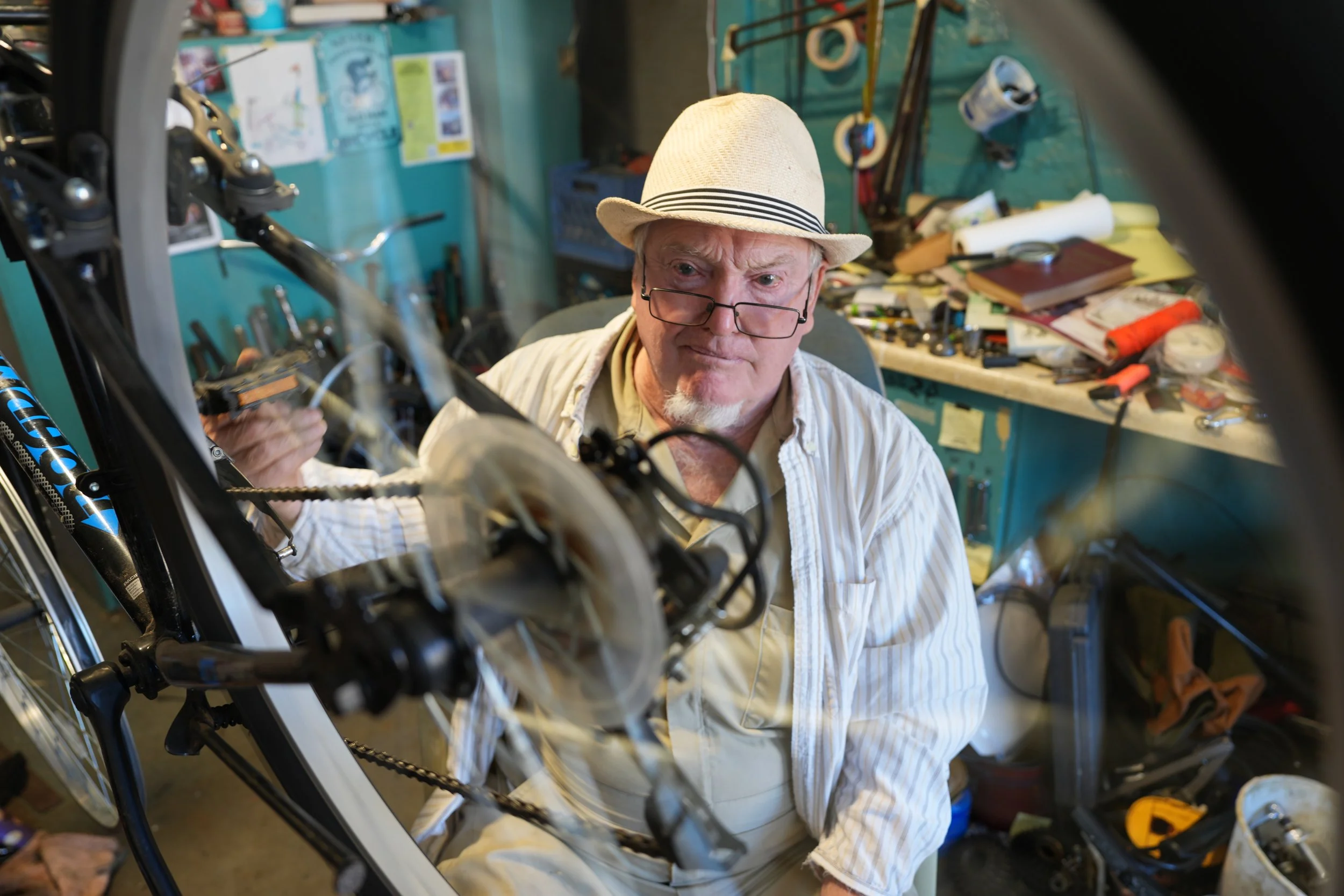 Harvey Chenault fixes a bike at his repair shop in Winchester, KY, on Oct. 20, 2026. "People say I've got a head full of useless information," says Harvey.