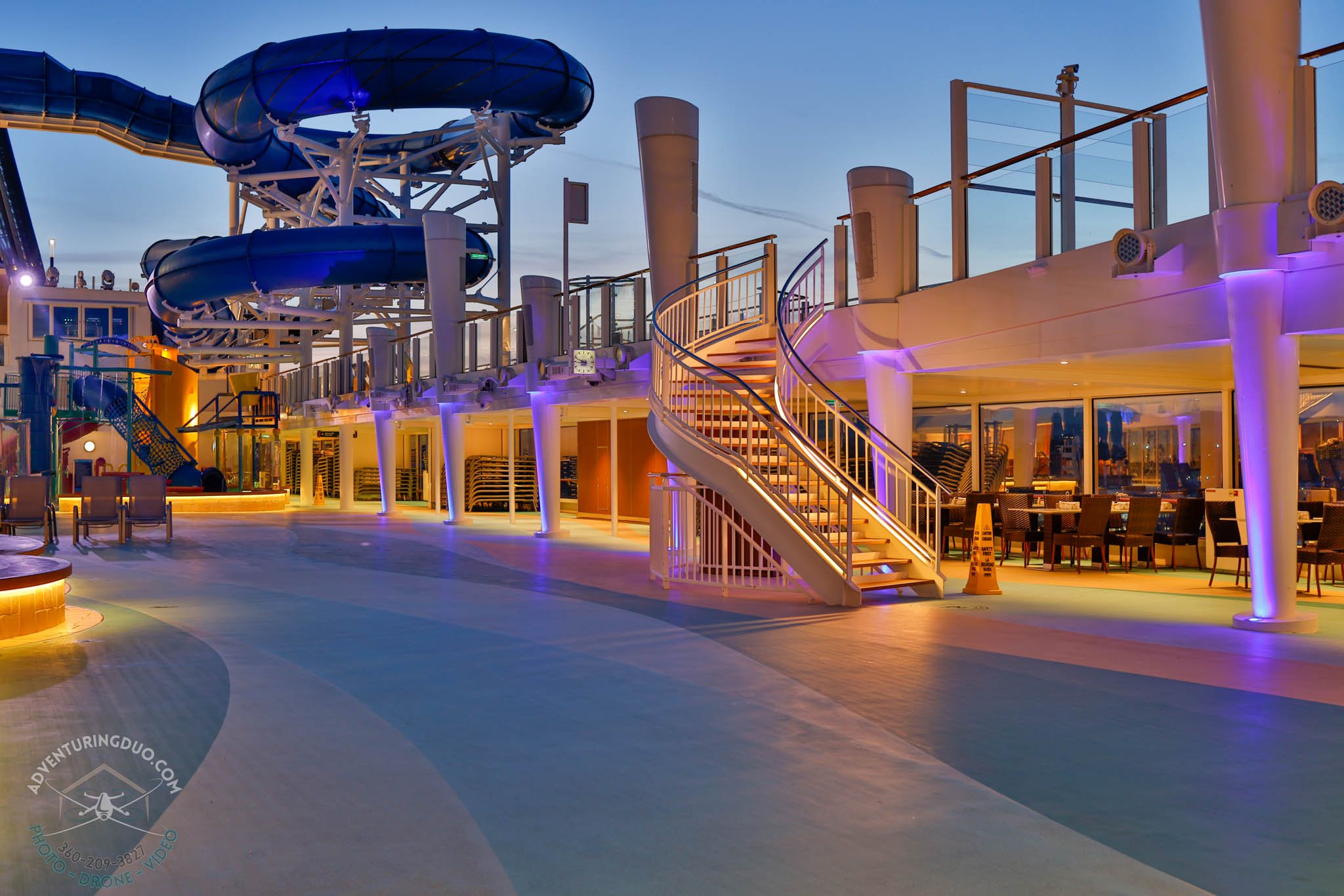 Water slide and deck lounge lit in purples and golds on Norwegian Encore
Professional cruise photo highlighting NCL’s illuminated deck design and playful luxury atmosphere after sunset, taken by Adventuring Duo in Victoria, BC.