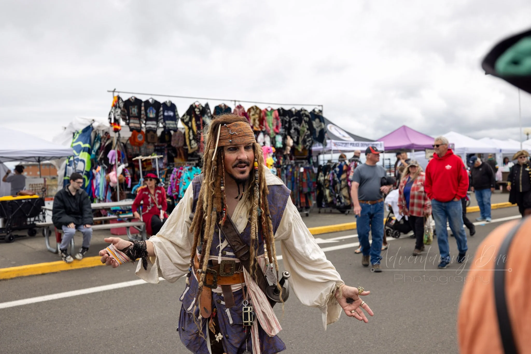 character Captain Jack Sparrow, posing for a photo while engaging with passerby. Westport, WA