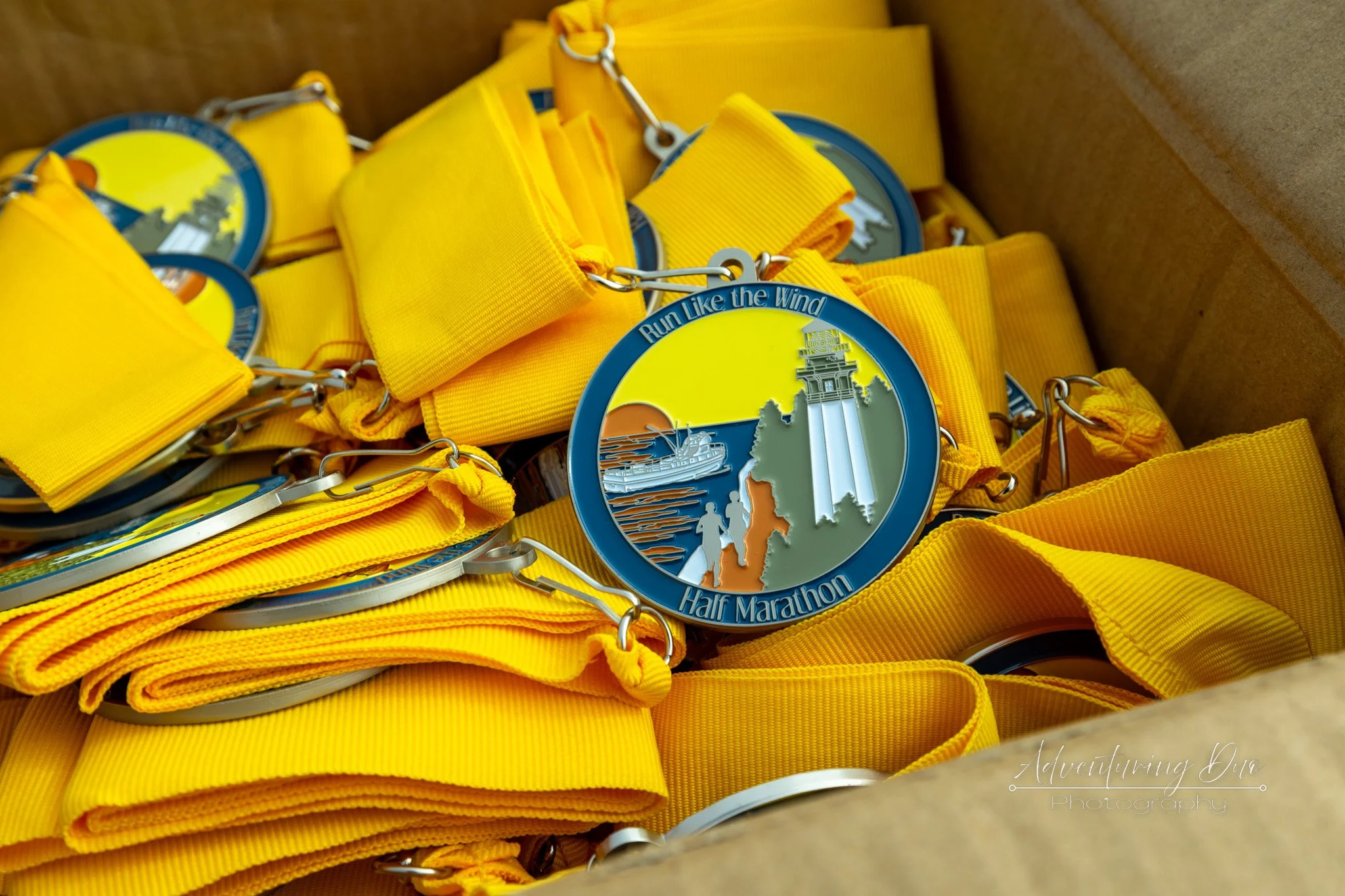 a box full of medals for the runners