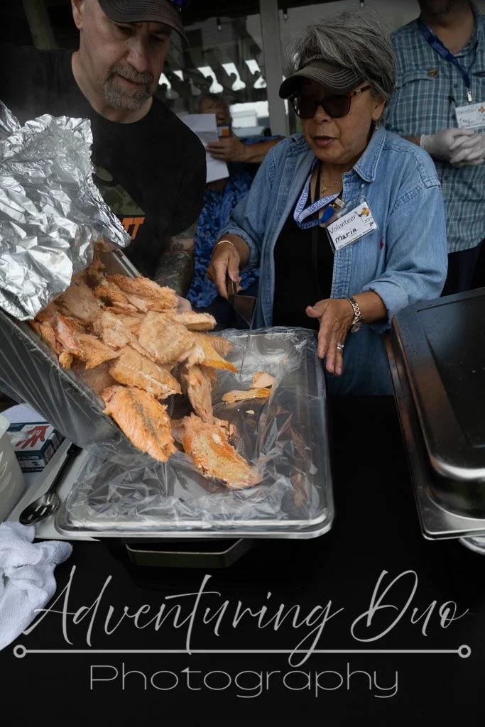 Volunteers panning up the freshly grilled salmon. Westport, WA