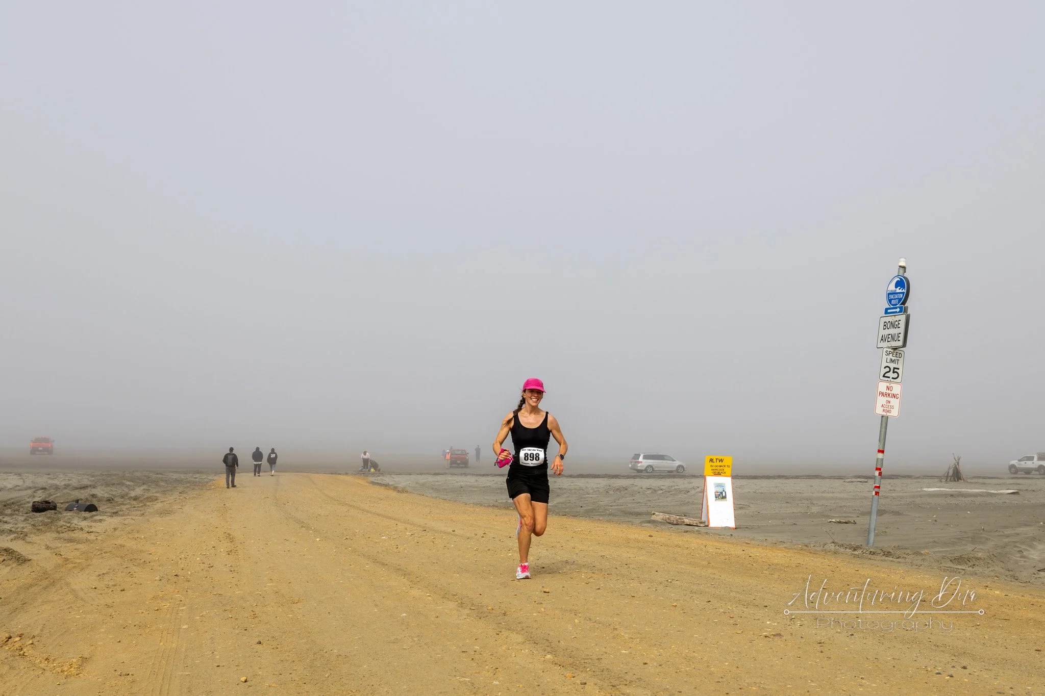 a female runner coming up to a checkpoint of the half marathon up the Grayland Beach, in Grayland Washington