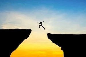 Person jumping a cliff