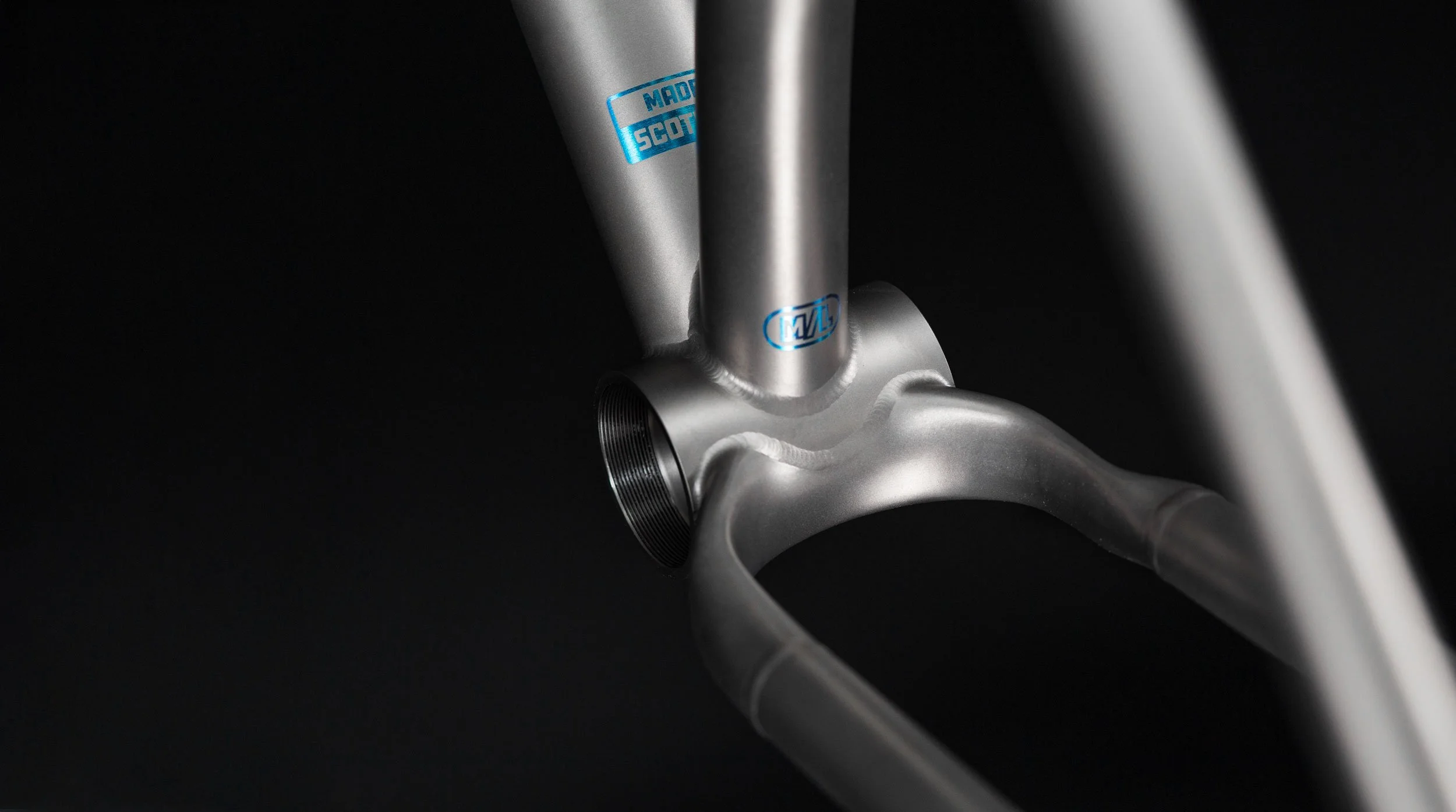 A detailed shot of the 3D-printed titanium yoke on the Zapr frame, designed for optimal tire clearance and component compatibility.