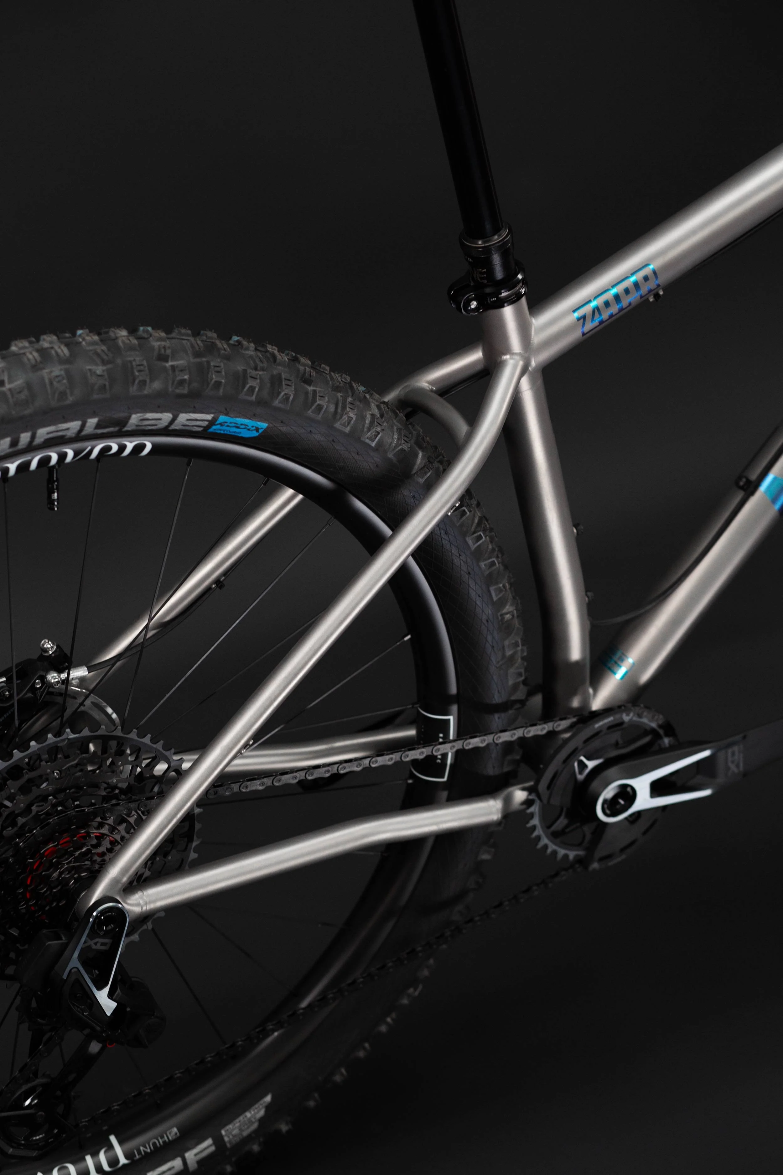Close up photograph showing a 2.6" 29er tyre in the Zapr titanium mountain bike.