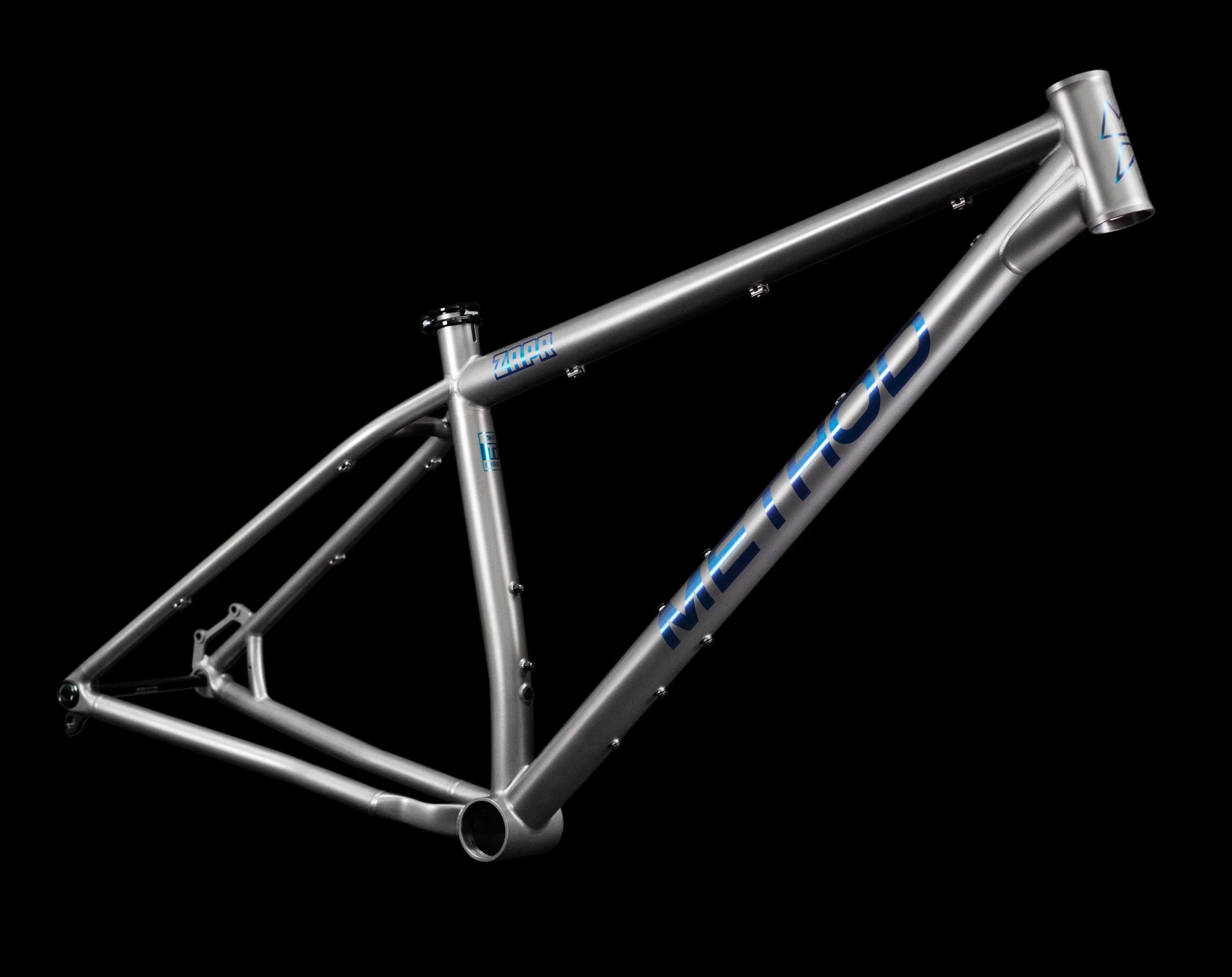 An angled profile of the Zapr titanium mountain bike frame, highlighting the anodised graphics and high quality welding.