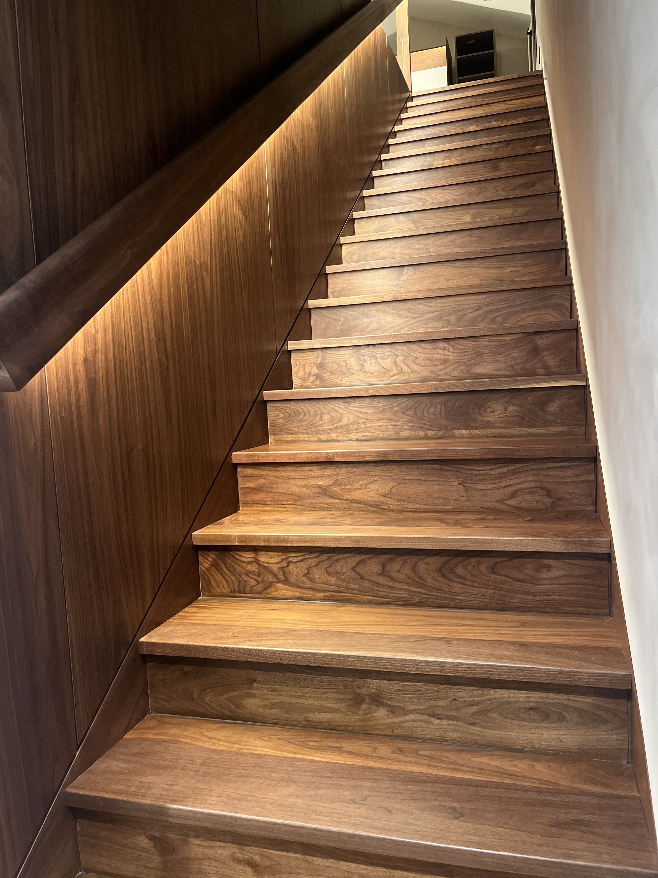 Walnut stairs, wall and handrail