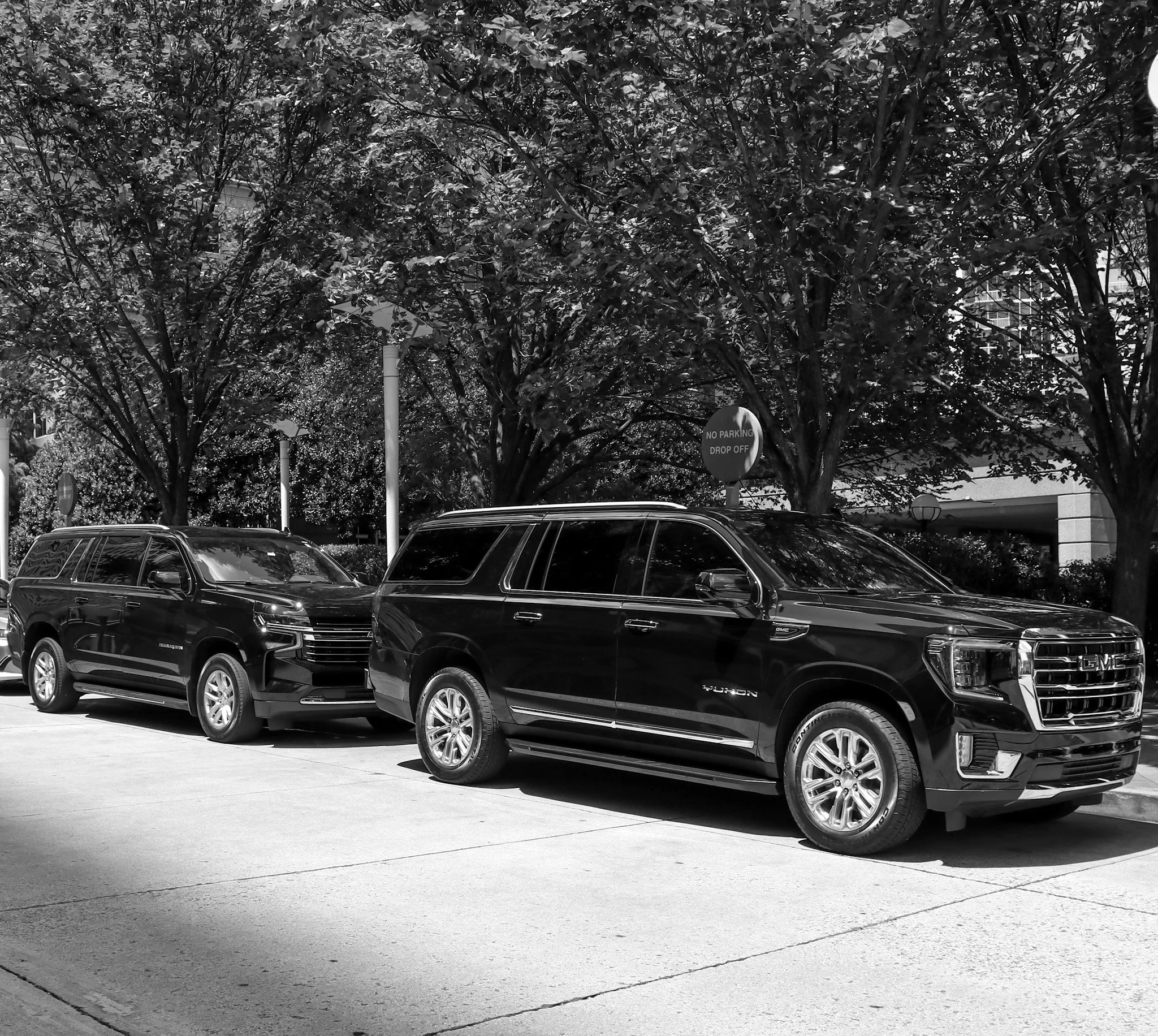 Escalade and yukon parked.jpeg