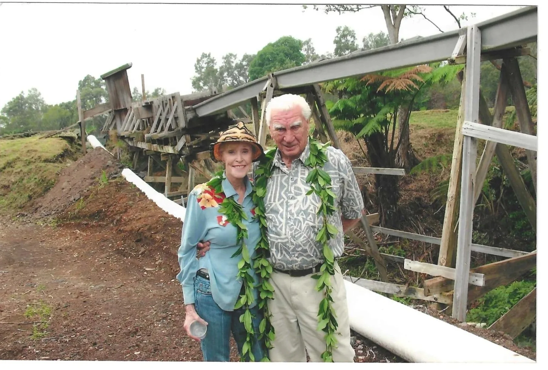 Ed and Jan Olson standing together beside the Keaīwa water pipe and trestle. Photo 6