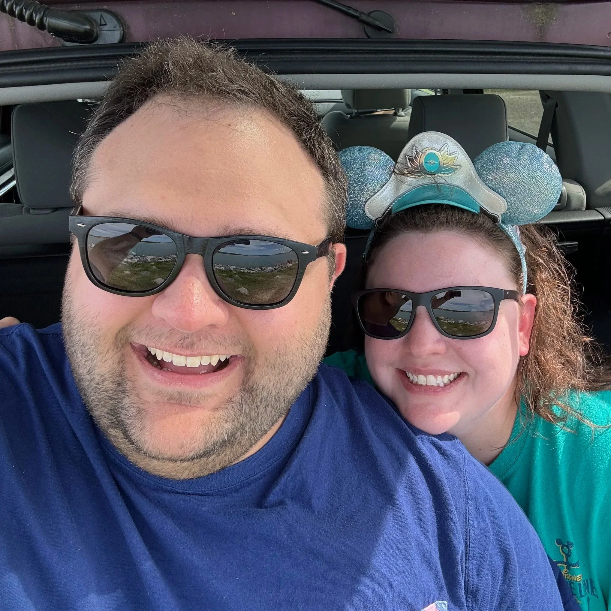 Disney travel creators Austin and Sarah smiling during a day at the theme parks