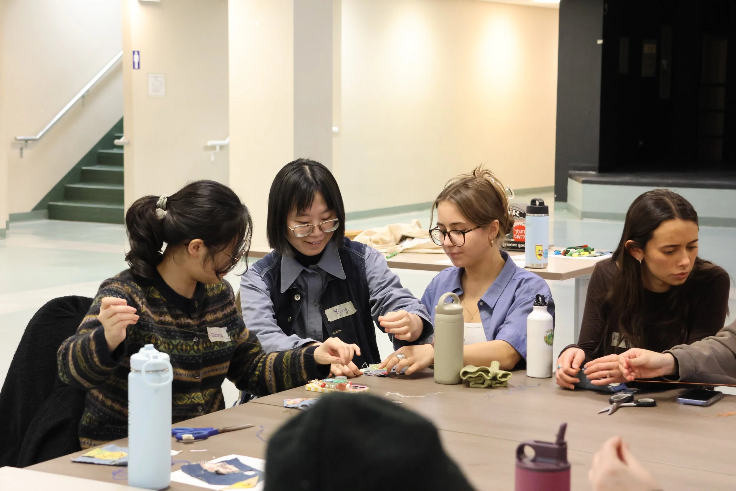Sophie Ryznar coaching participants through mending techniques.