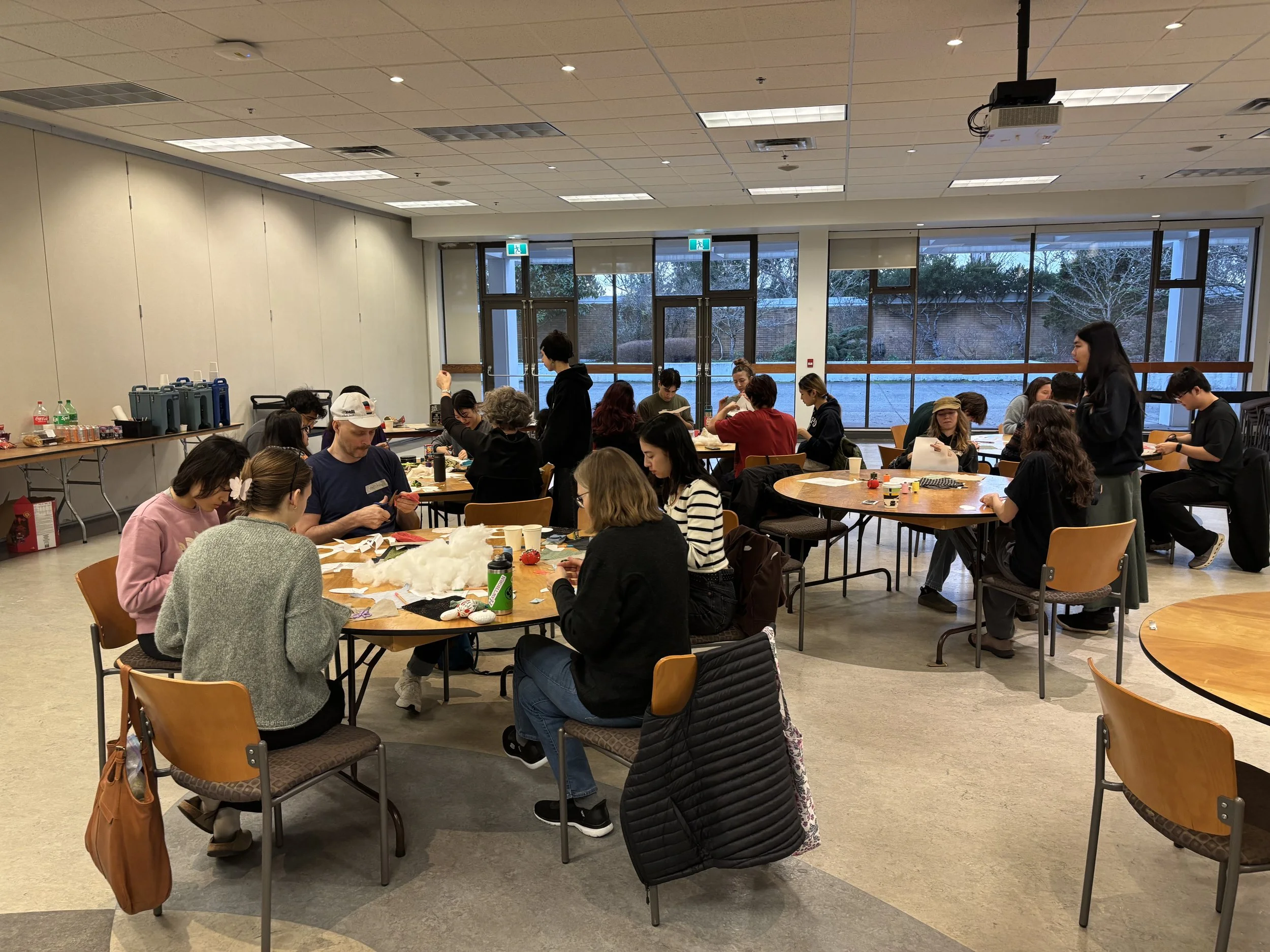 Participants for workshop 2 on construction, learning to follow along to a basic pattern to create their own simple keychains. 