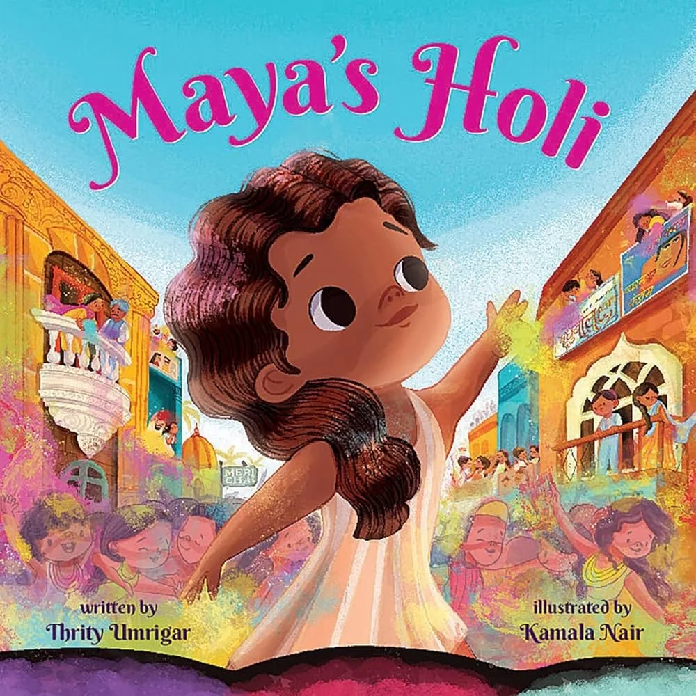Cover of a children's book titled "Maya's Holi," featuring a girl with brown hair throwing colored powder during Holi celebrations in a vibrant Indian street scene.