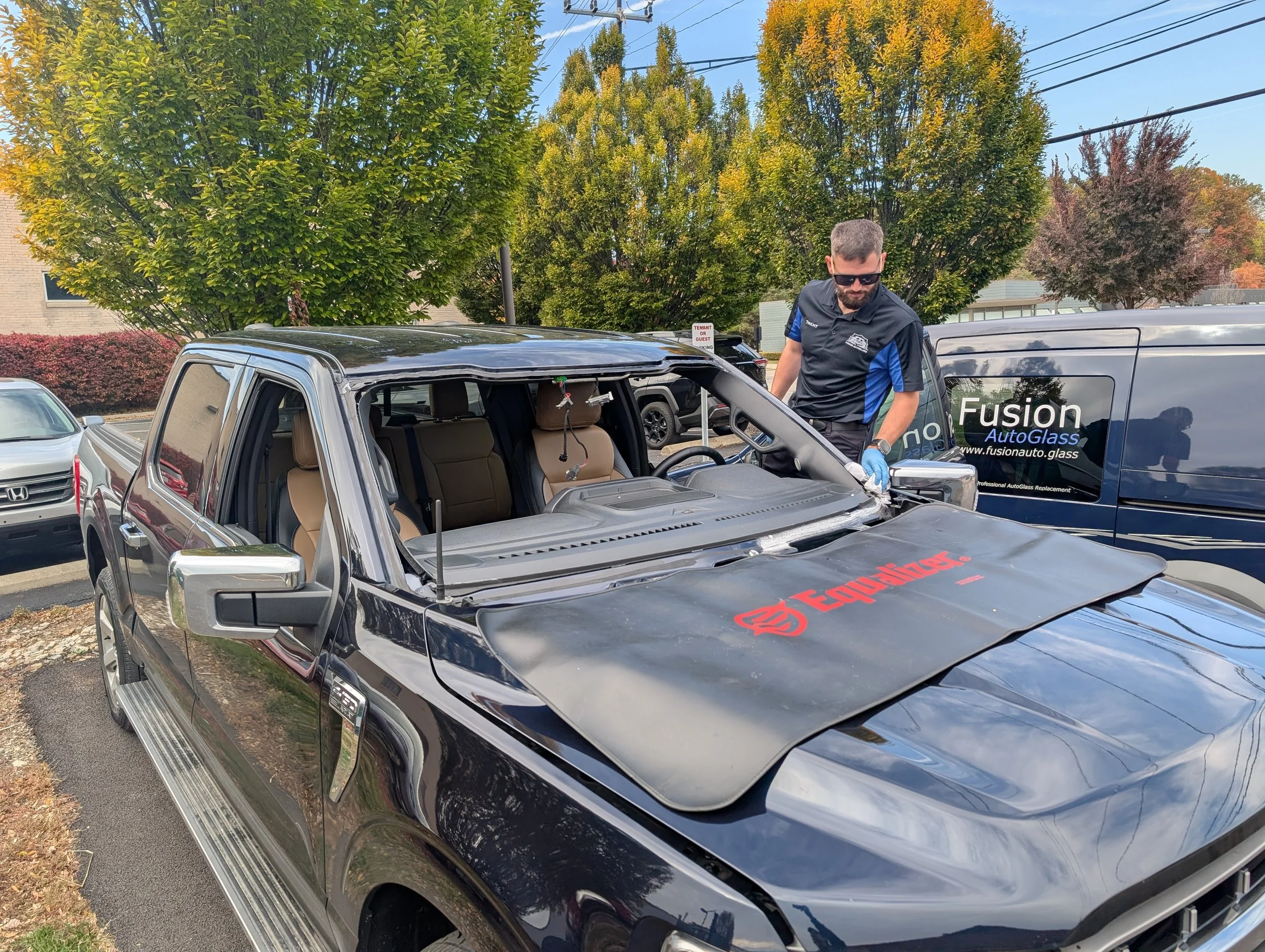Technician wiping the bond area of the car