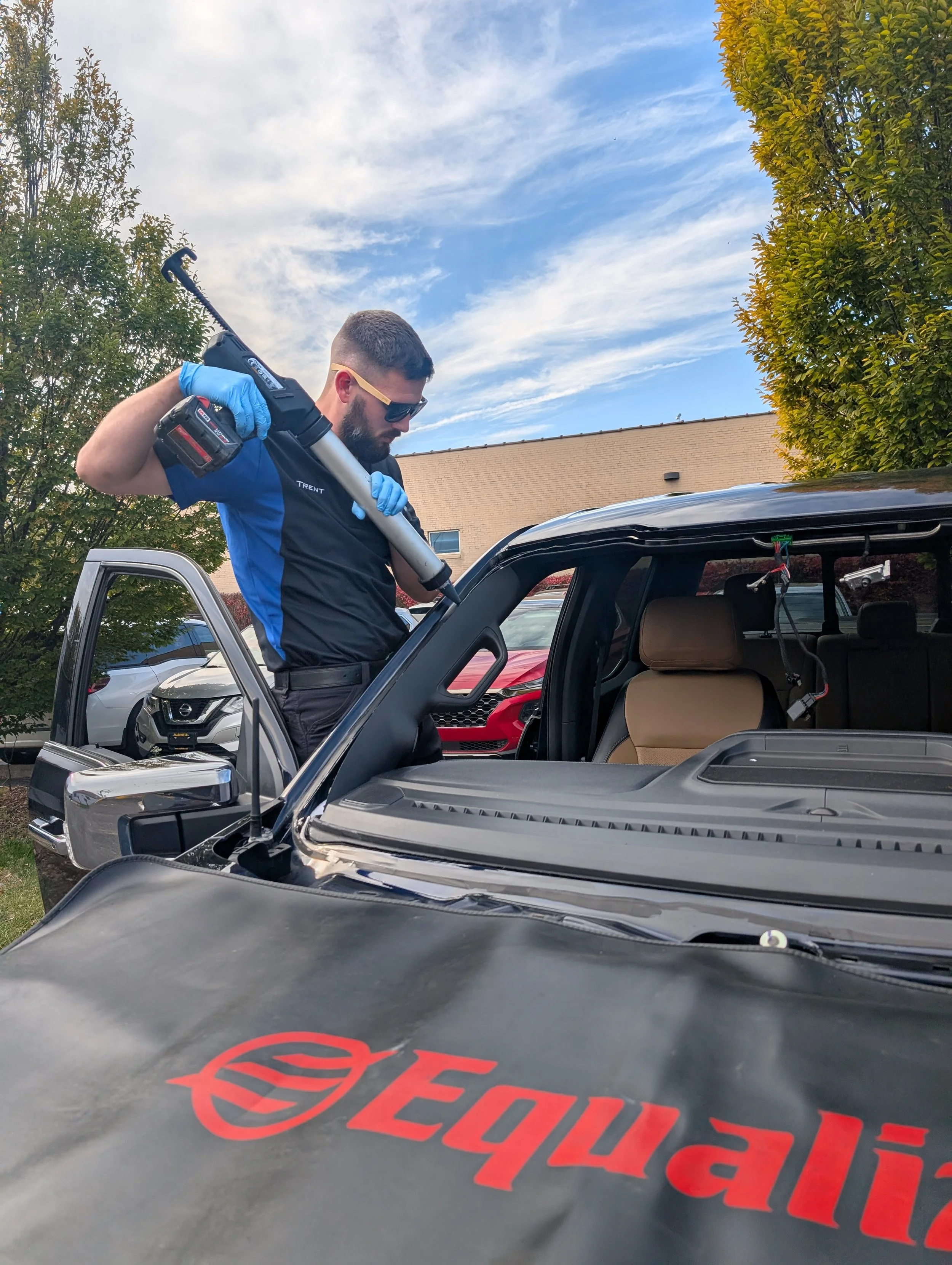 Technician shooting urethane on the car