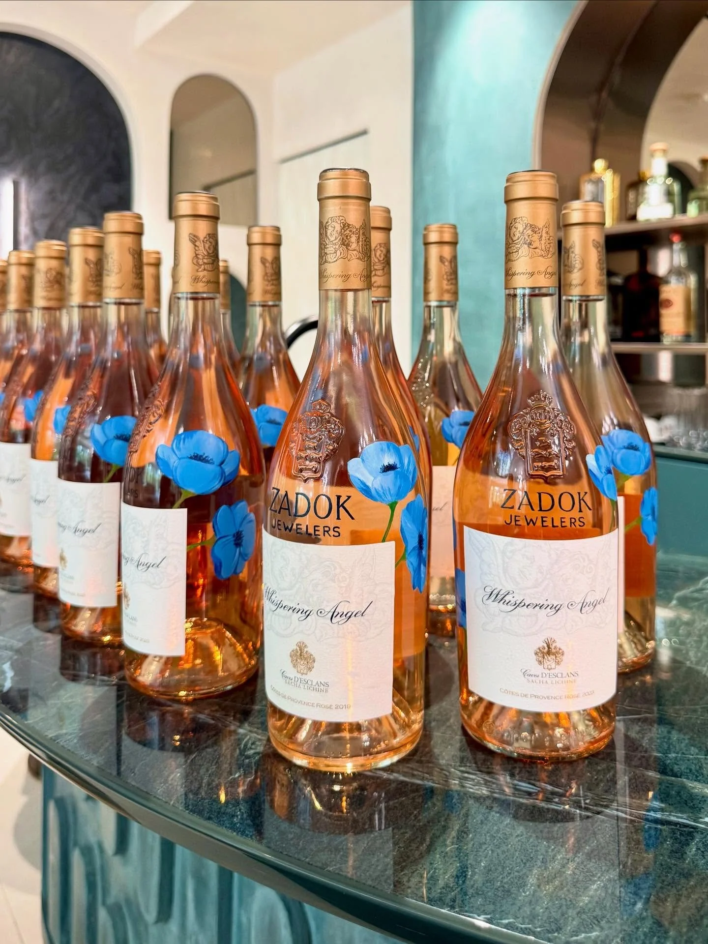 Custom art, but make it drinkable 🥂

36 bottles of @thewhisperingangel just got a makeover with hand-painted @zadokjewelers logos and custom florals! Comment if you want to BTS footage of how I freehand painted these beauties 🎨