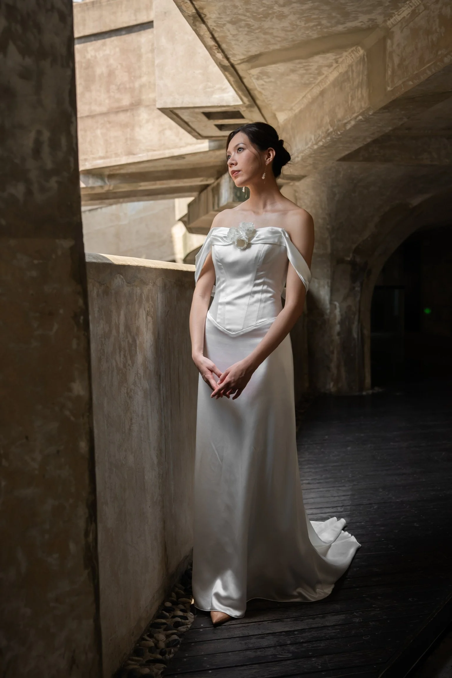 Celine-brudekjolen set forfra med formet corsage, blød skulderdrapering og blomsterdetalje