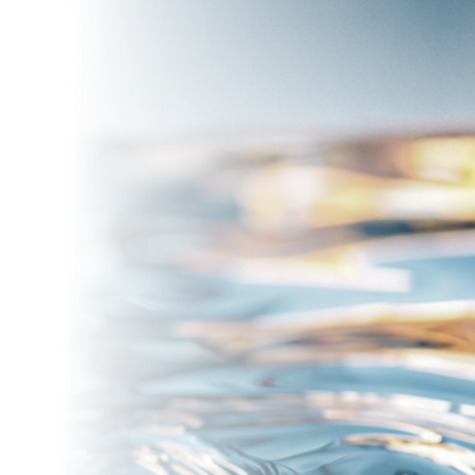 Close-up of rippling water with reflections and variations in color and light.