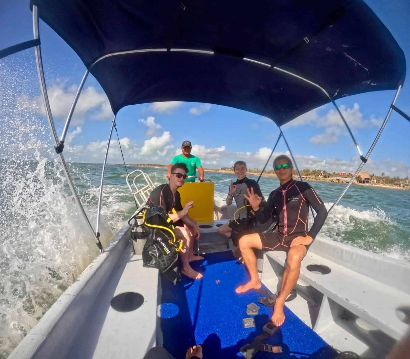 Padi students getting their open water dives at tulums mesoamerican barrier reef, on a boat on the way to the dive sites