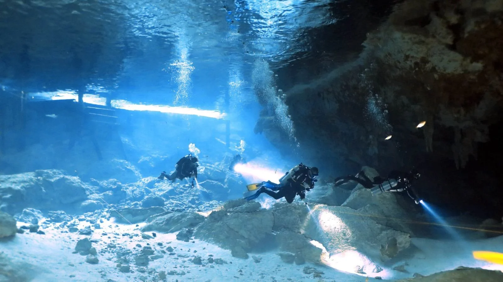 Certified diver exploring a cenote cavern system near Tulum, Mexico — Mexidivers cenote diving package