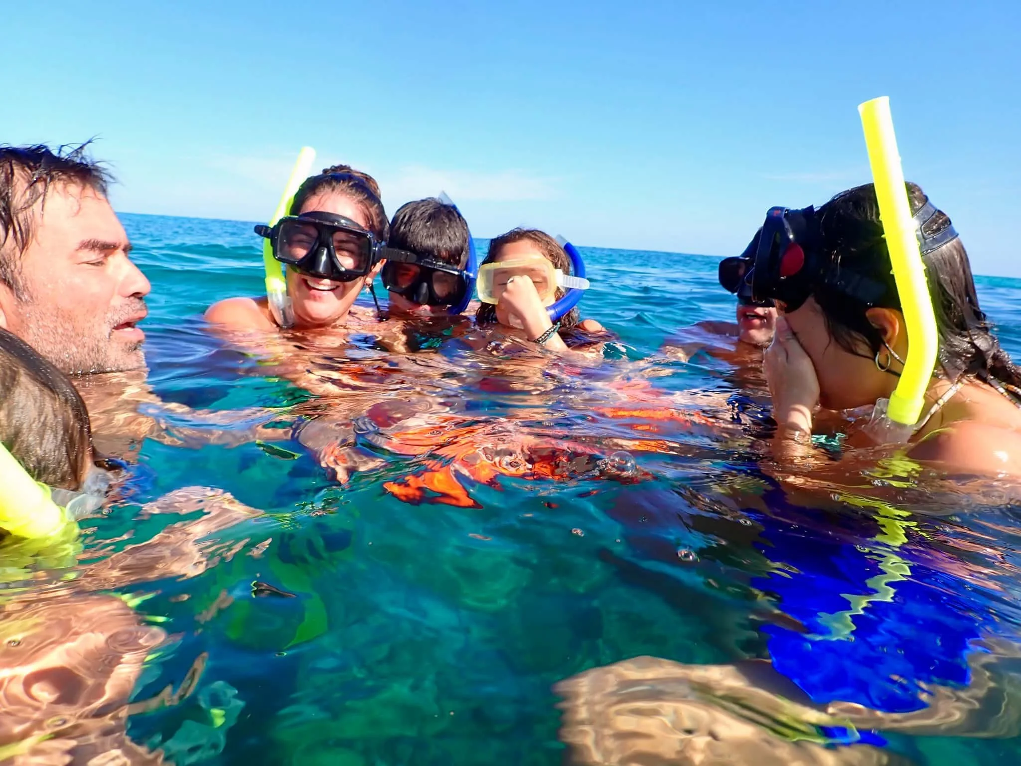 happy family on a snorkeling tour in tulum mexico on the reef with mexidivers