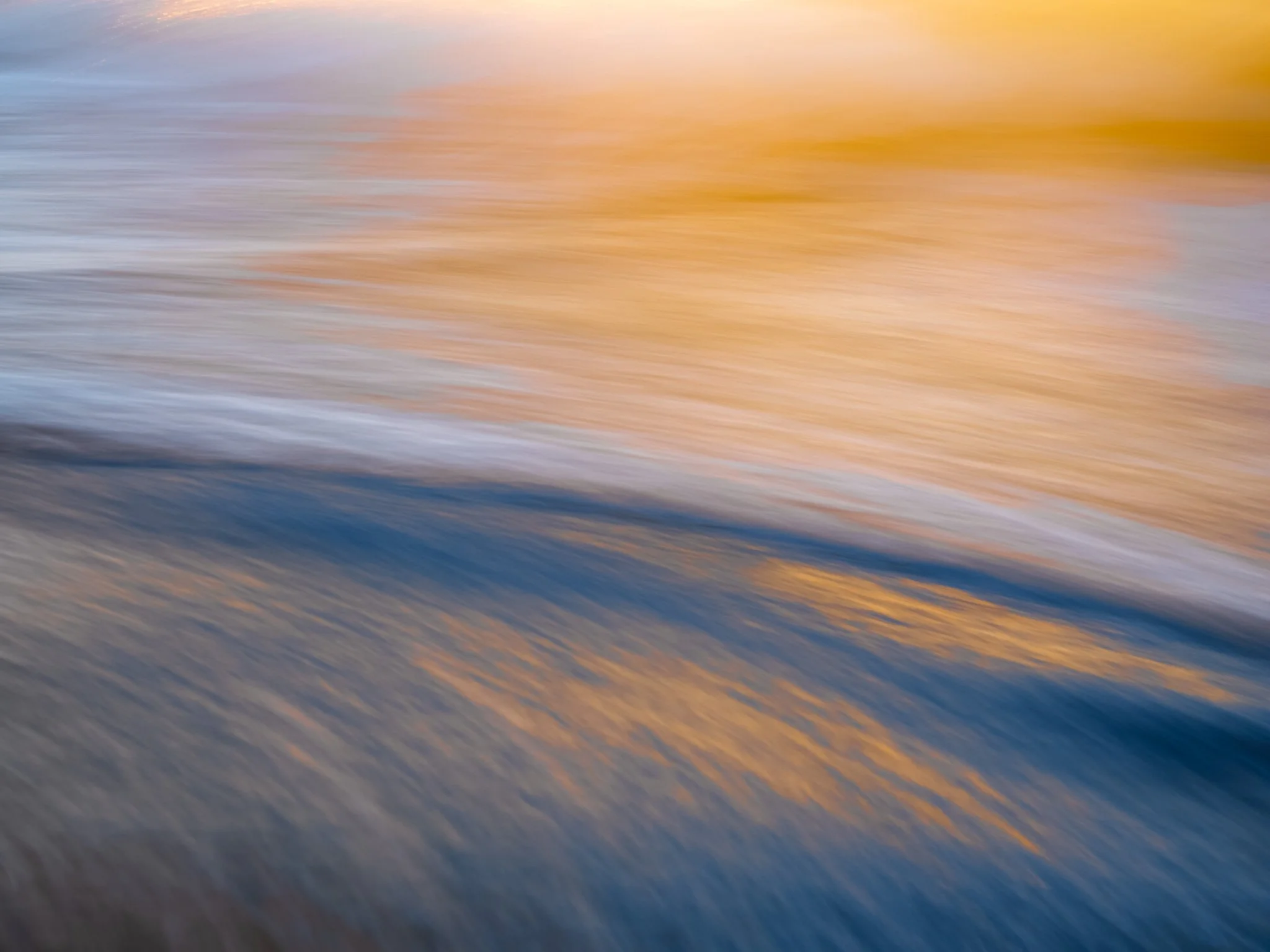 Intentional camera movement abstract photo of Pacific Ocean waves and sunset colors at Bodega Dunes in California.