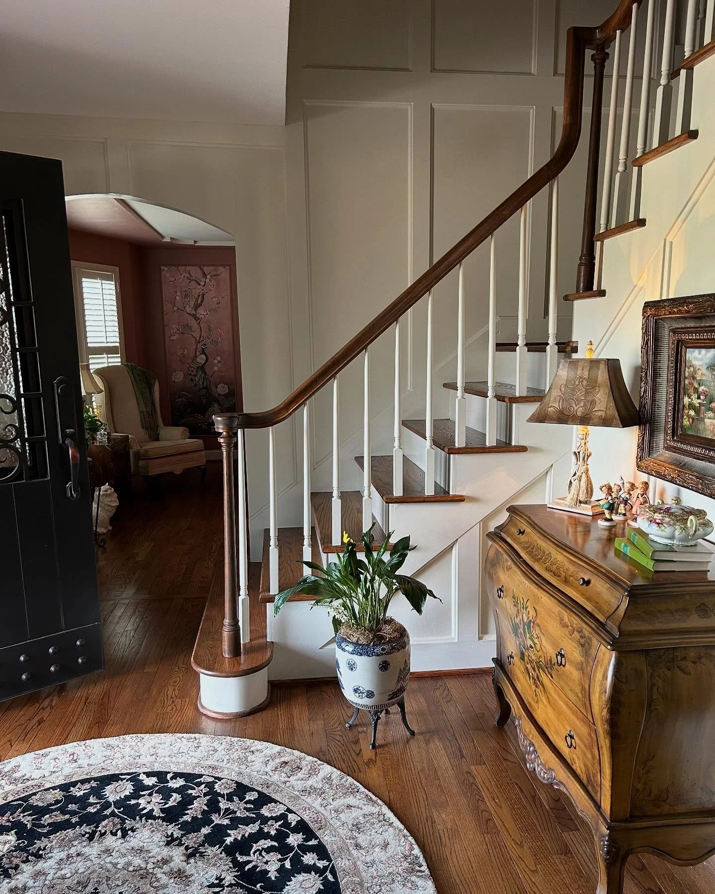 Applied molding added some depth and class to this foyer. It was only fitting for this Tudor style home to have wood detailing. Swipe for the before. #appliedmolding #foyerdesign #traditionaldesign #firstimpressions #beforeandafter