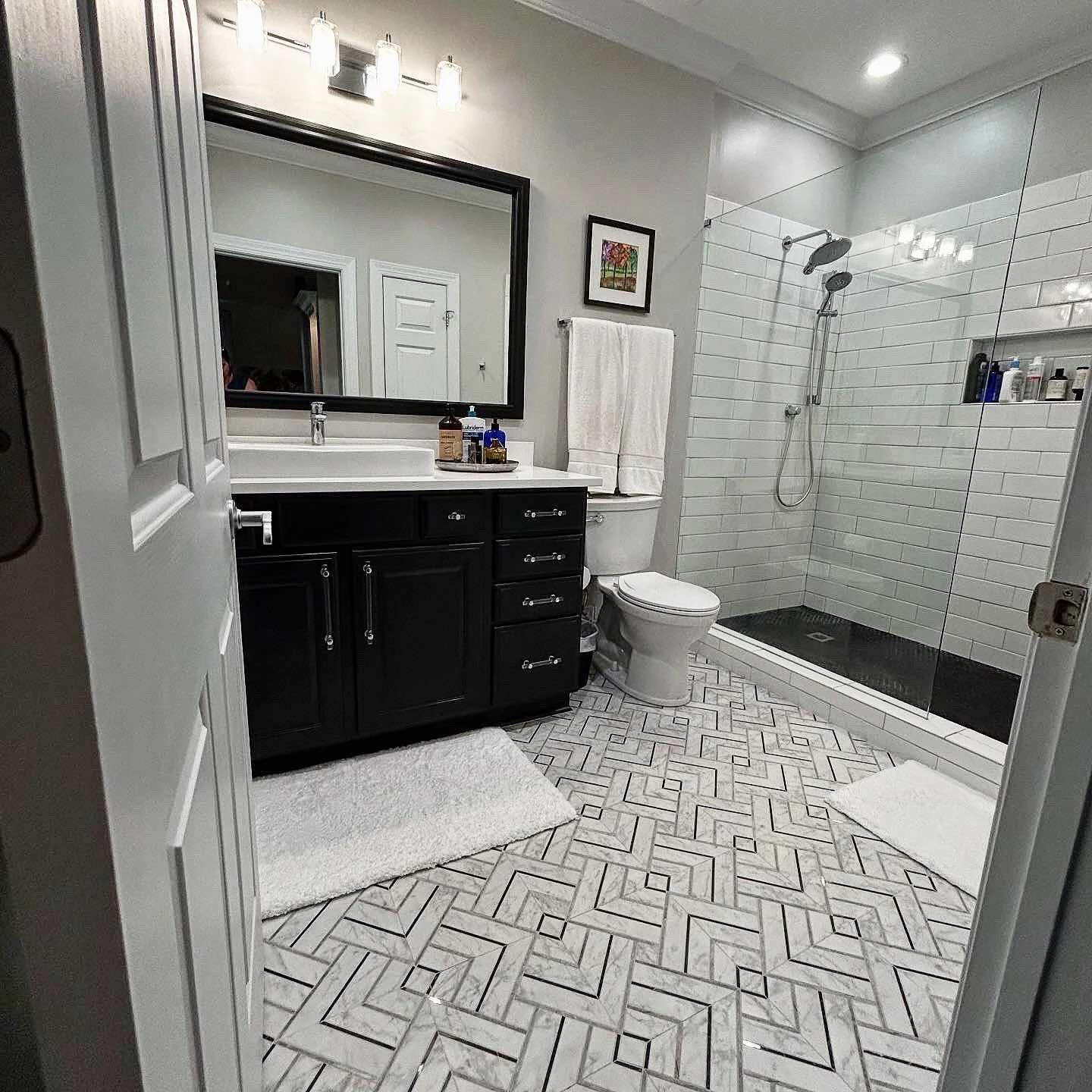 It&rsquo;s amazing to see how changing one foundational element can turn this client bathroom into something so lux. Just by changing the floor tile this bathroom is now so much brighter and sophisticated. Swipe to see the before. #bathroomdesign #re