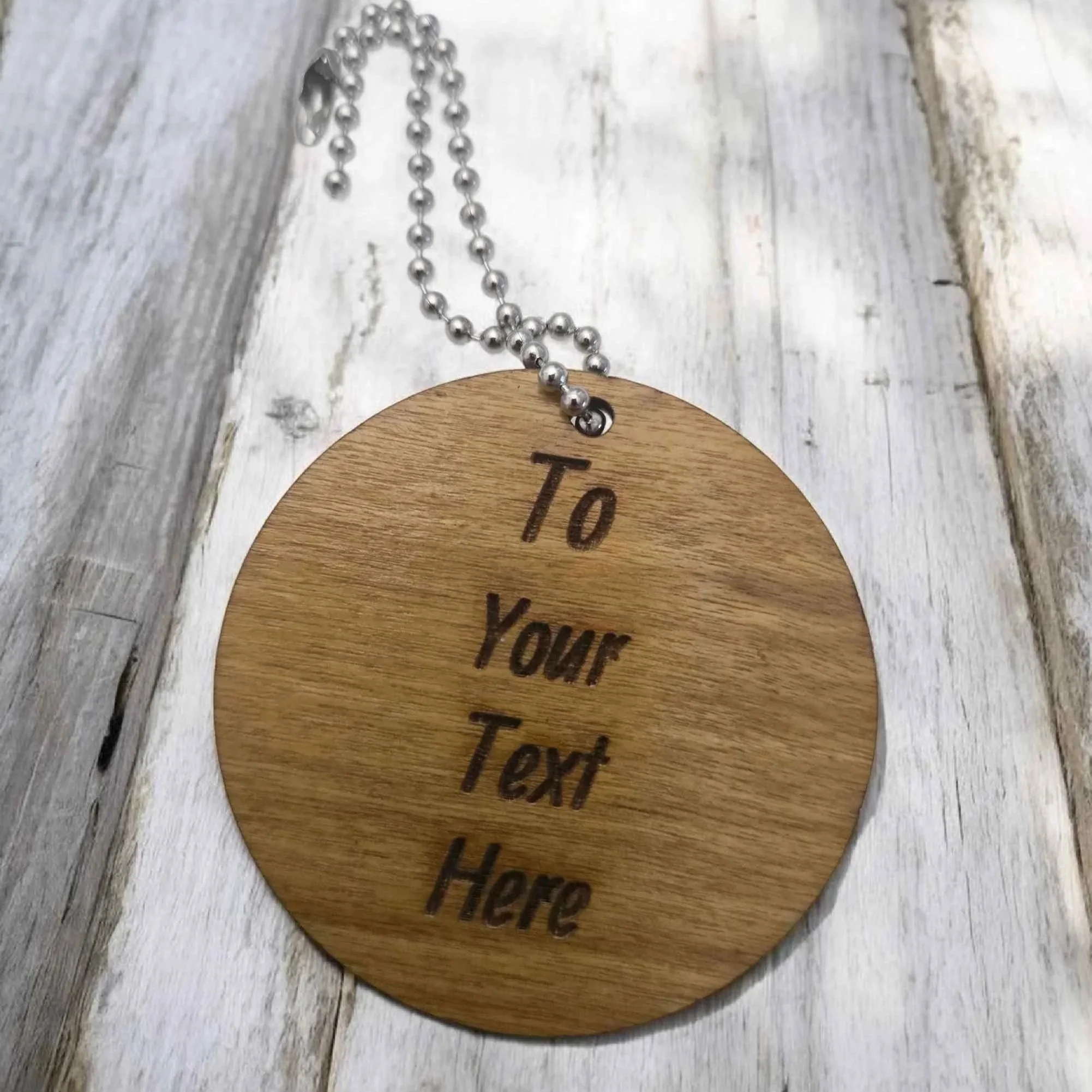 Personalised laser-engraved guitar round tag—British handcrafted gift.
