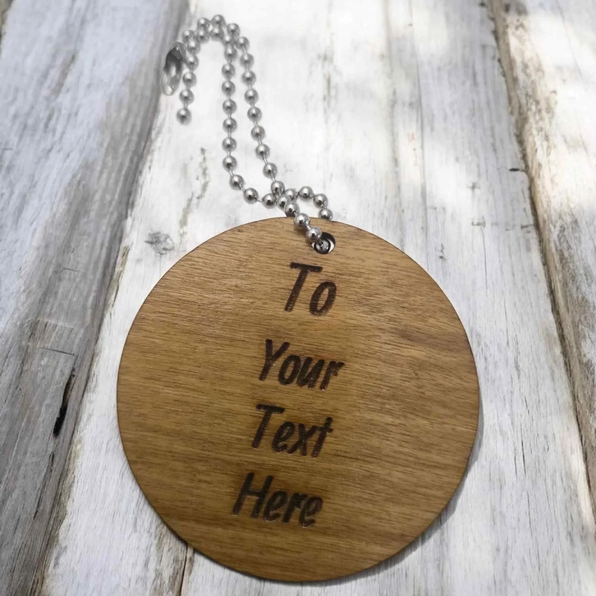 Personalised round wooden tag with custom message—perfect for golfing retirement or birthday gifts.