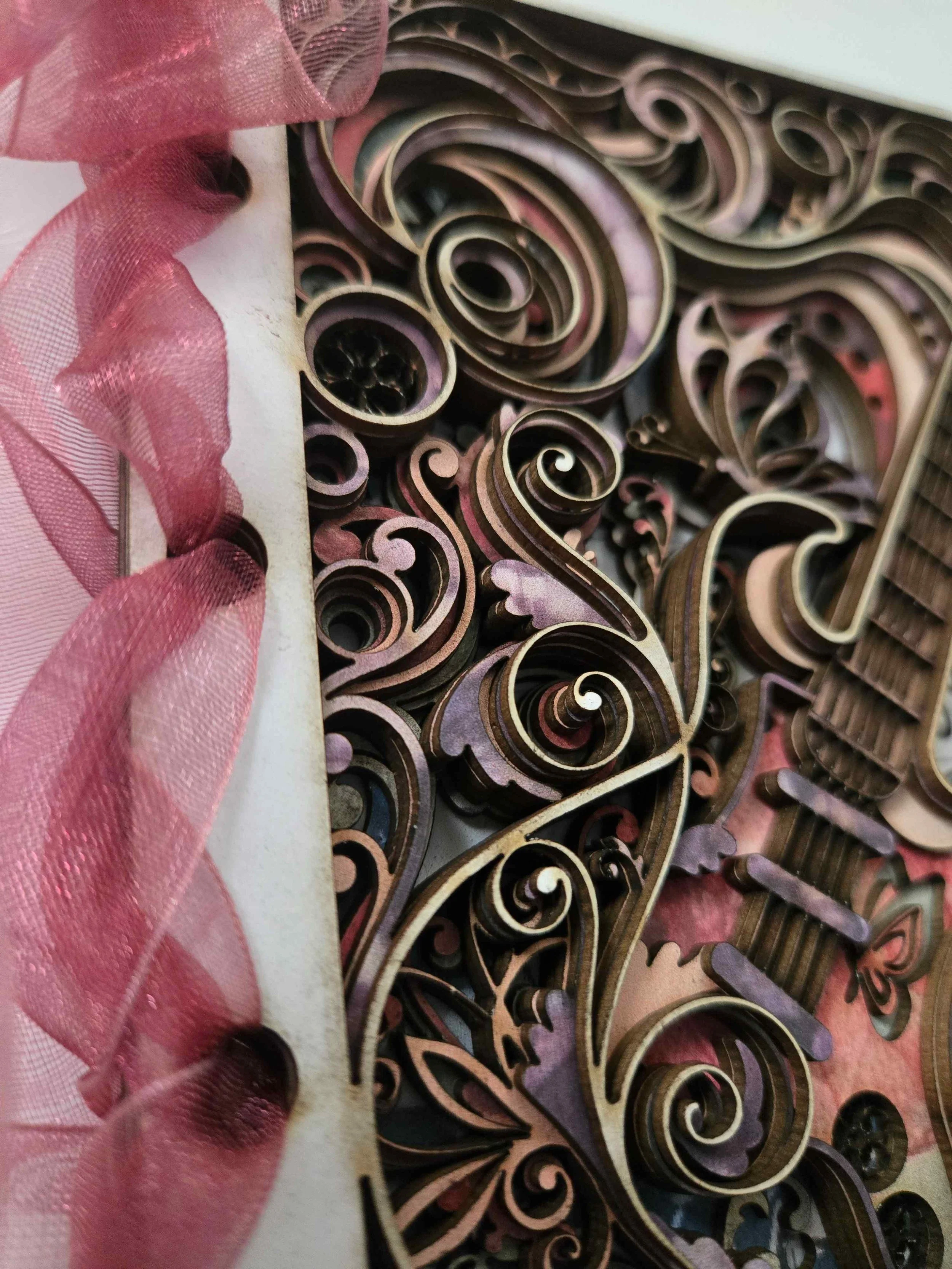 lose-up of the 8 layers of pink and cream mount board showing 3D depth.